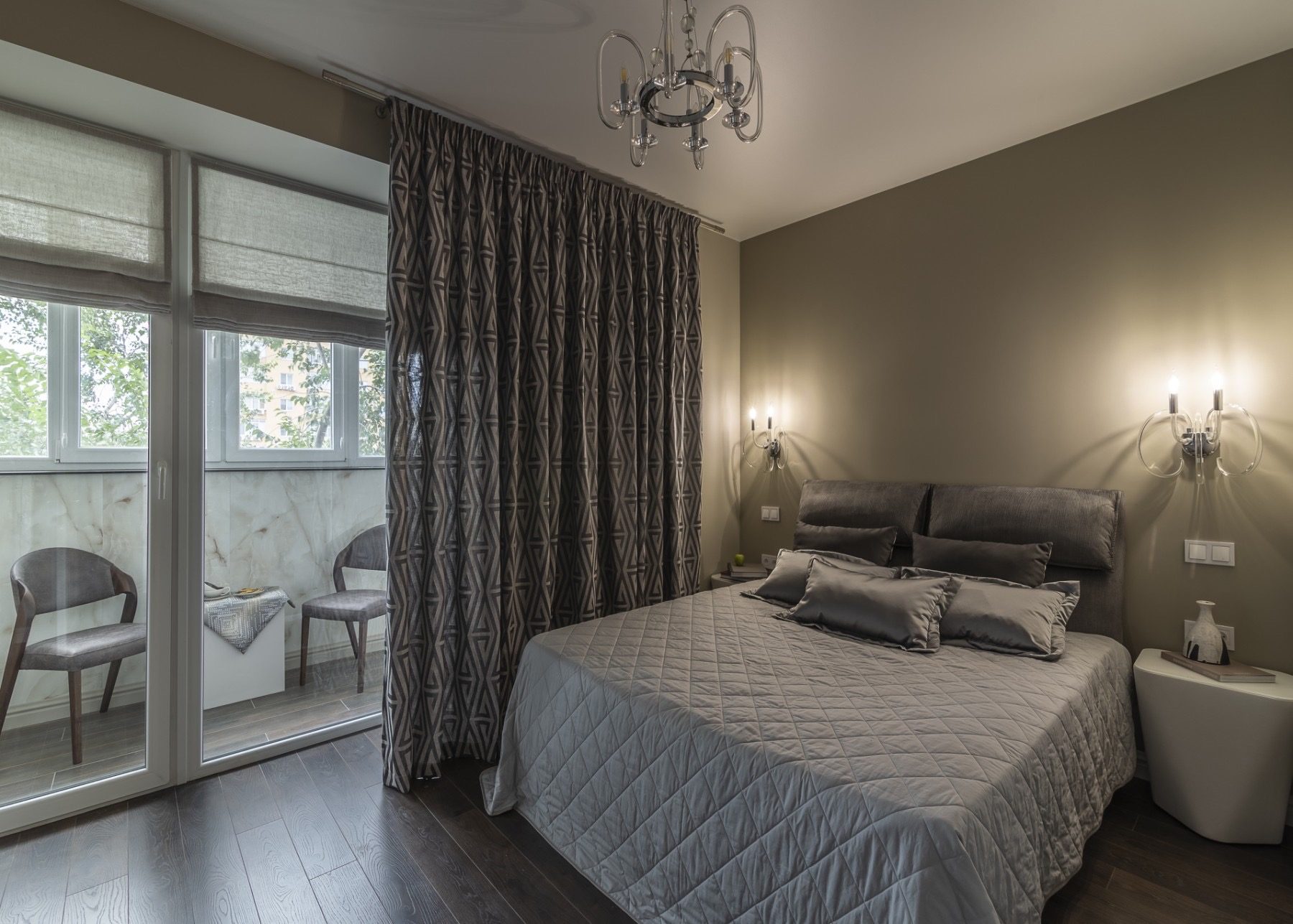 Bedroom with balcony doors and grey bedding