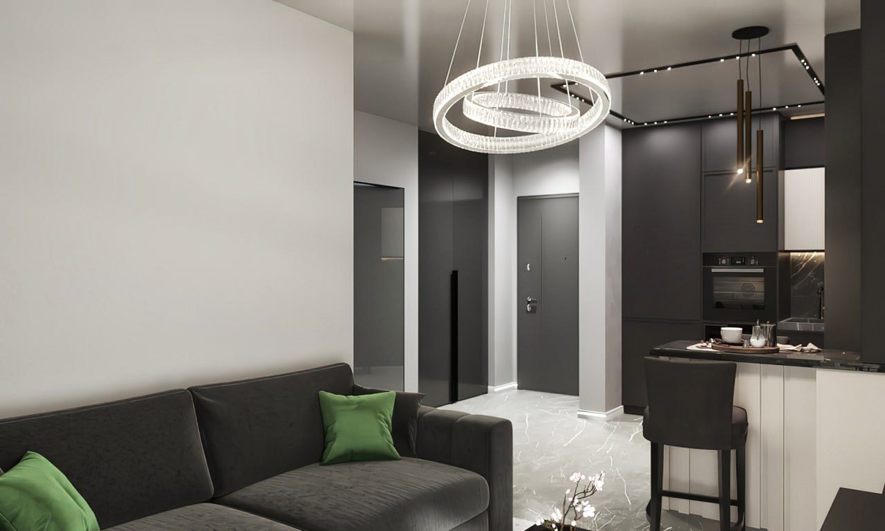 Living room with a ring chandelier and dark kitchen