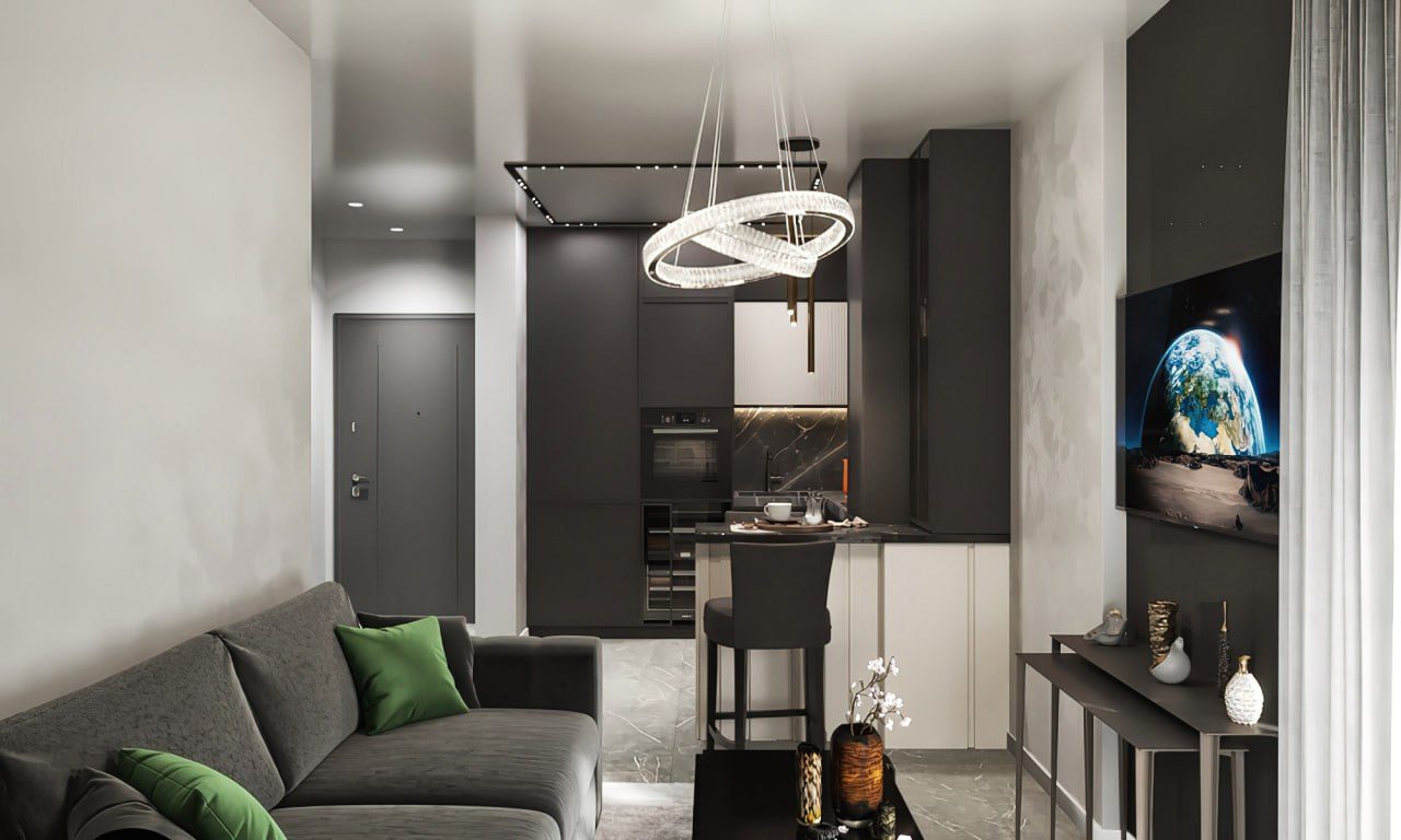 Living room with a dark kitchen and a ring pendant light