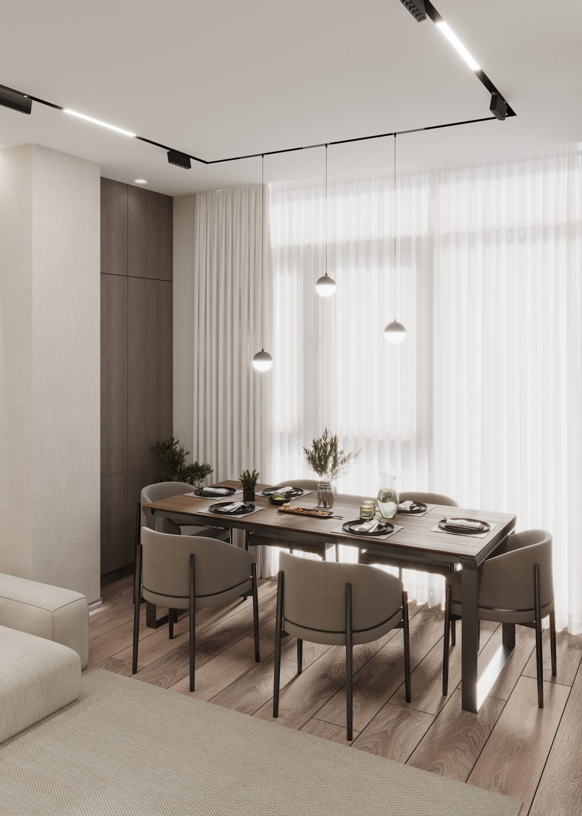 Dining area with a wooden table, upholstered chairs and pendant lights